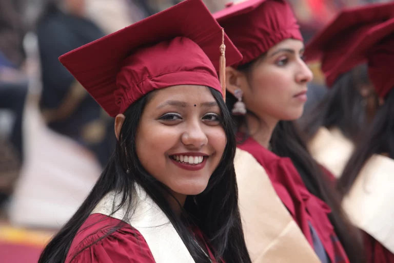 Smiling Vedica Scholar in a graduation cap and gown, representing the career support programme at Vedica Scholars Programme